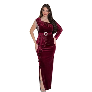 Detail of burgundy velvet gown with chain tassel shoulder and rhinestone waist belt