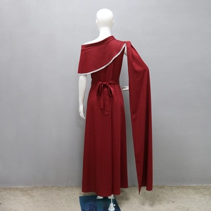 Detail of burgundy one-shoulder evening gown with silver sequin trim and long floor-length sash