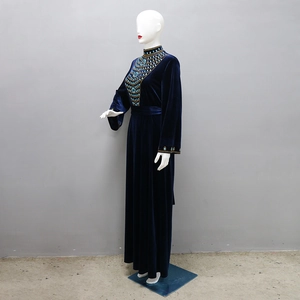 Detailed close-up of blue velvet evening dress with sparkling rhinestone beadwork