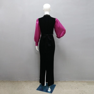 Rear view of velvet slim dress featuring magenta lantern sleeves and a back slit detail