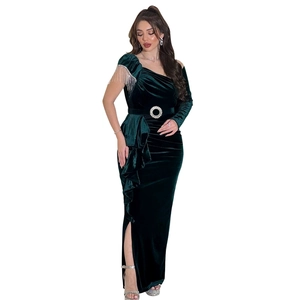 Deep green velvet evening gown featuring a silver chain tassel shoulder and high slit detail