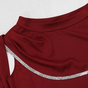 Detailed close-up of wine red evening dress featuring elegant silver rhinestone neckline decor