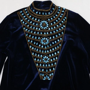 Detail of navy blue velvet dress with teardrop crystals and gold beaded embroidery