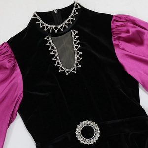 Close-up of rhinestone wave collar and velvet bodice detail on the slim-fit gown