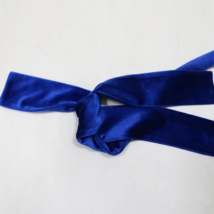 Detail of royal blue velvet tie-waist sash with a soft texture and luminous finish