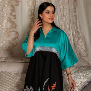 Elegant teal and black color-block dress with floral embroidery and gold sequin trim