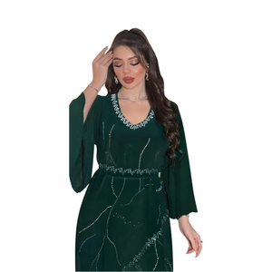 Detail of dark green chiffon kaftan robe showing intricate rhinestone patterns and belt