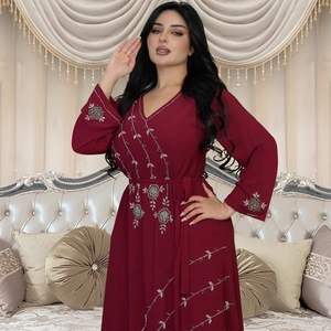 Detailed view of rhinestone embroidery and delicate beading on a burgundy V-neck maxi dress