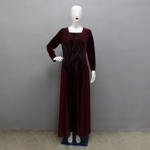 Detailed view of the sparkling rhinestone feather pattern on a wine red velvet evening dress