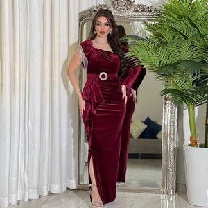 Elegant burgundy velvet one-shoulder maxi dress with tassel chain and waist buckle detail