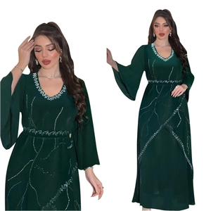 Detail of rhinestone patterns and V-neck on the dark green chiffon abaya robe with belt