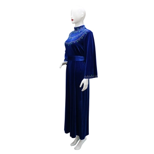 Detailed view of green beaded embroidery on luxury navy velvet kaftan dress