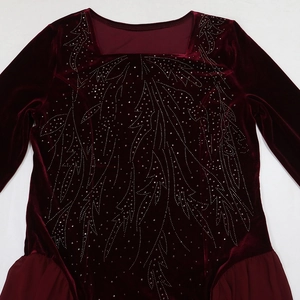 Detailed close-up of velvet evening gown with sparkling rhinestones and chiffon patchwork