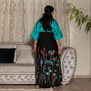 Back view of a chic color-block green and black floral embroidered maxi dress gown