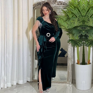 Detail of silver tassels on green velvet evening dress with side slit and belt