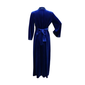 Detail of royal blue velvet robe showing waist belt bow and intricate beaded embroidery