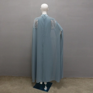 Close-up of light blue dress showing silver sequin embroidery and long metallic tassels