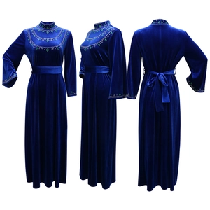 Detail view of royal blue velvet robe dress with green sequin leaf embroidery