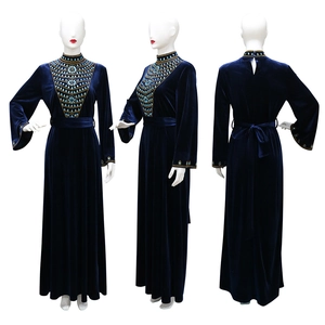 Macro detail of royal blue velvet evening gown showing intricate golden beadwork on chest