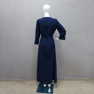 Back view of navy blue long sleeve abaya dress with rhinestone cuffs and matching belt