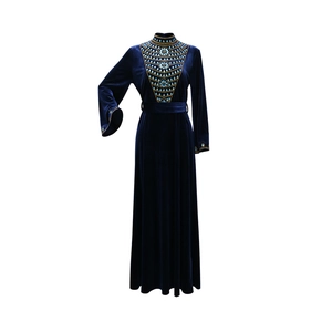 Close-up of intricate beadwork and sequins on dark blue velvet Jalabia evening dress