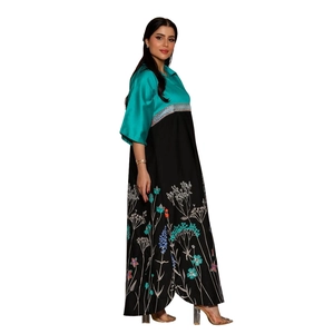 Close-up of vibrant floral embroidery on color-block satin Abaya dress hemline
