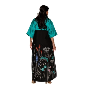 Close-up of elegant floral embroidery on the hem of the two-tone satin abaya robe