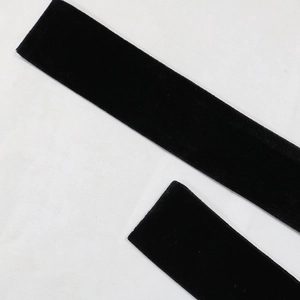 Detailed macro view of black velvet ribbons with smooth texture and clean cut edges