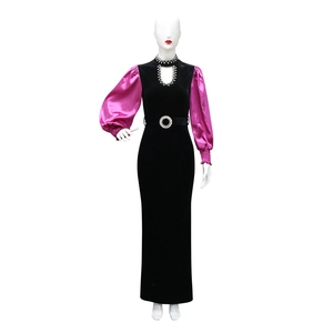 Detail of velvet gown featuring contrast satin puff sleeves and rhinestone neckline decoration