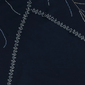 Macro view of wave-patterned rhinestones on elegant navy blue chiffon fabric detail