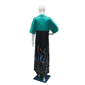 Detail of floral print and satin finish on a contrast color maxi dress for women