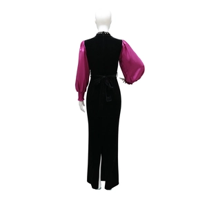 Detail of velvet party dress featuring pink satin lantern sleeves and waist bow