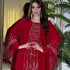 Detail of silver sequin geometric patterns on red chiffon abaya sleeves and bodice