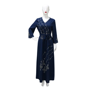 Detail of floral sequin embroidery and waist tie on this navy blue long sleeve V-neck abaya