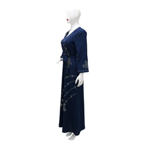 Detail of navy blue abaya dress featuring elegant white rhinestone floral patterns