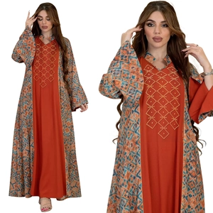 Detail of rust red Abaya with golden bead embroidery and geometric ethnic prints