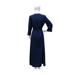 Detail view of navy blue long dress back with rhinestone star cuffs and matching waist belt