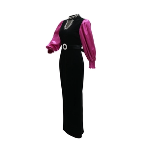 Detail view of rhinestone buckle and velvet fabric on elegant evening dress gown