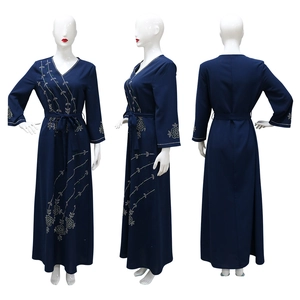 Detailed views showing floral rhinestone patterns on the dark blue long sleeve kaftan dress
