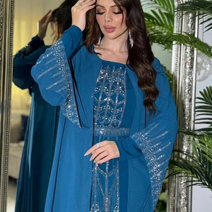 Detail of navy blue abaya with silver rhinestone geometric patterns on cuffs and edges