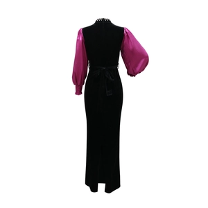 Detail view of the velvet gown back with fuchsia puff sleeves and elegant waist bow tie