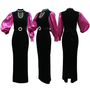 Detail view of velvet dress showing crystal neckline and purple satin lantern sleeves