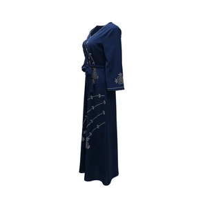 Detail of dark blue V-neck Abaya dress with rhinestone vine floral patterns on silk-like fabric