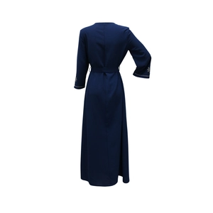 Rear view of navy blue maxi dress with rhinestone embellishments on cuffs and waist belt