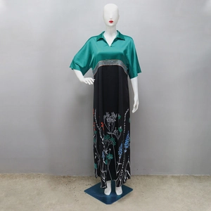Detail of a floral print patchwork maxi dress featuring a green short sleeve silk collar