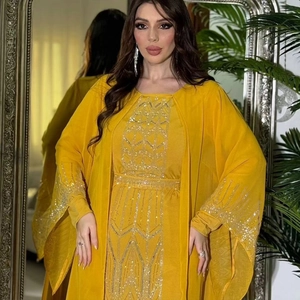 Detail of silver geometric embroidery and sequins on bright yellow chiffon abaya dress