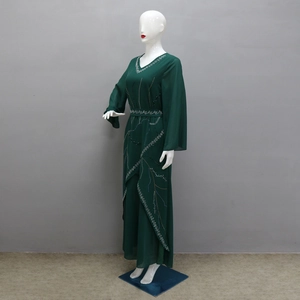 Detailed view of silver rhinestones and beadwork on a dark green chiffon long maxi dress