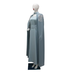 Close-up of gray-blue maxi dress with sparkling sequin tassels and rhinestone neckline