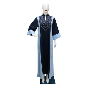 Gros plan sur la broderie de strass argentés et les détails du col de cette robe caftan
