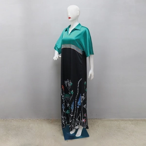 Detail of V-neck satin bodice and floral print hem on a long contrasting maxi dress
